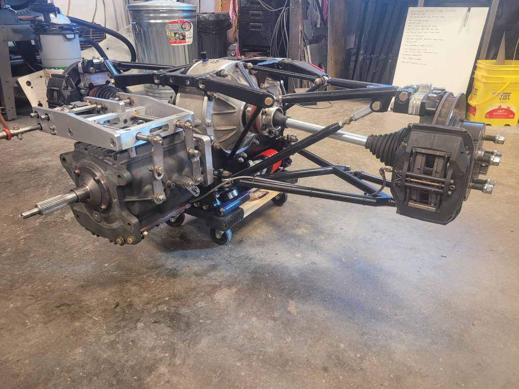 Transaxle consisting of a Jerico 4 speed dog ring road race transmission, Winters 10 inch quick change with torque biasing diff, adaptor plates, and custom shift linkage.